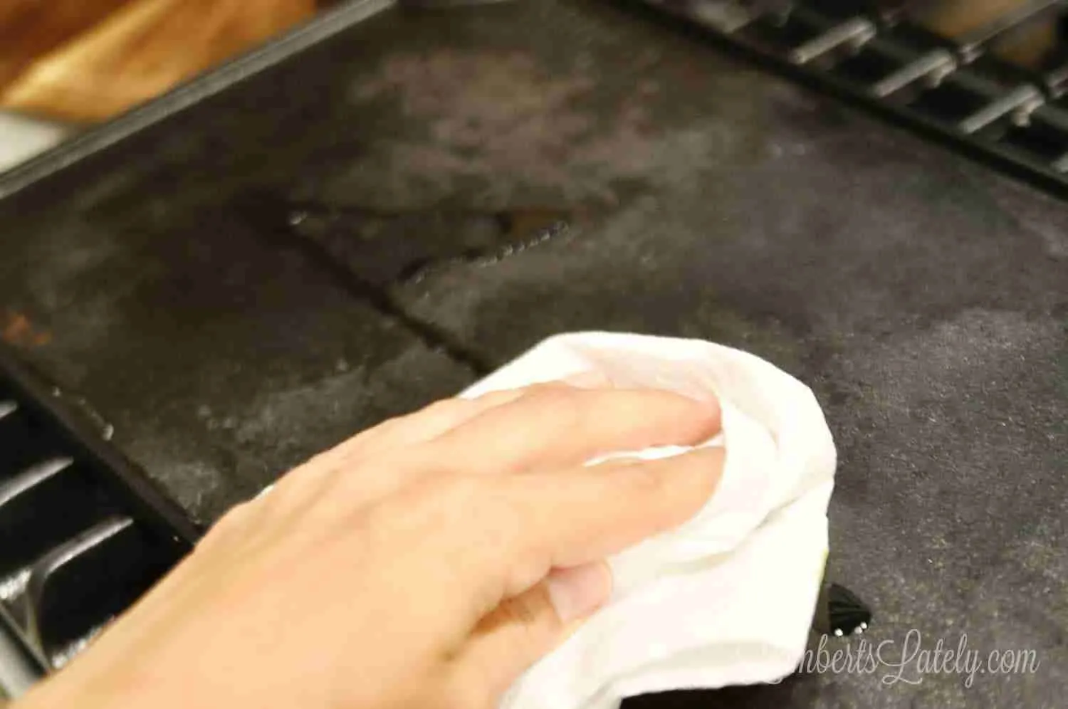 rubbing olive oil on a cast iron griddle