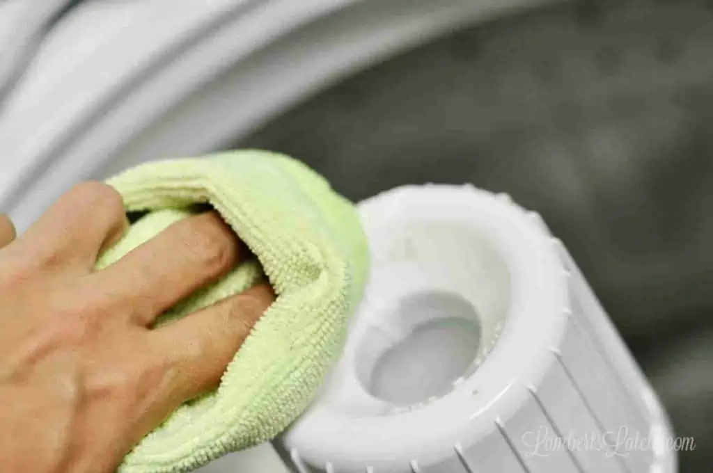 wiping fabric softener dispenser with a microfiber cloth.