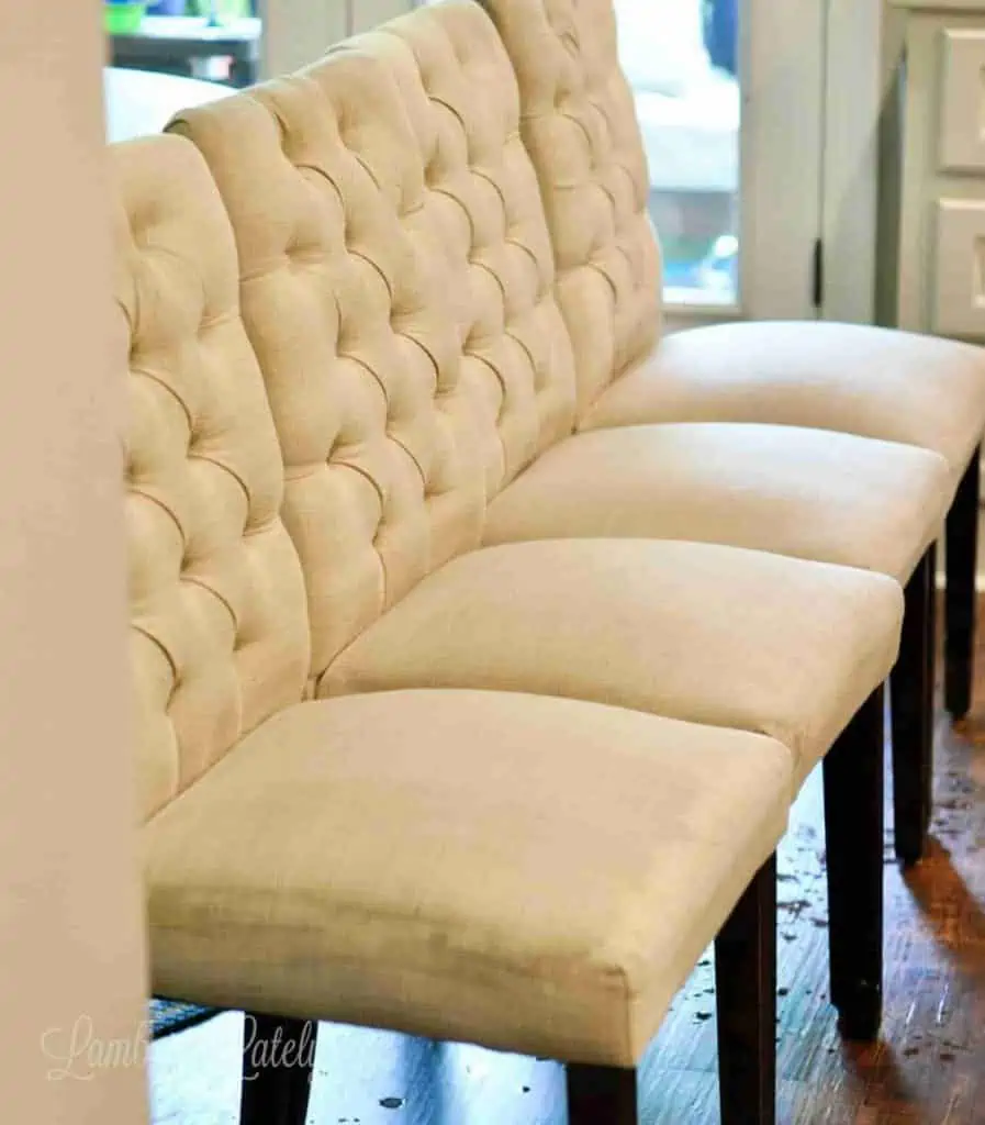 four upholstered chairs lined up in a row.