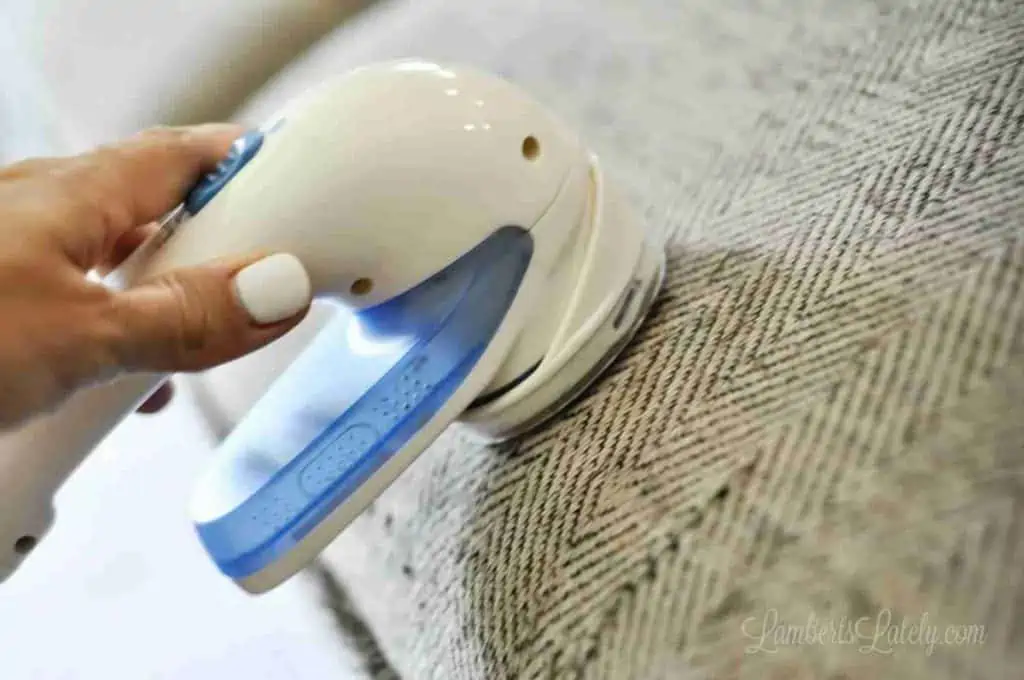 removing fuzz from a couch with an upholstery shaver