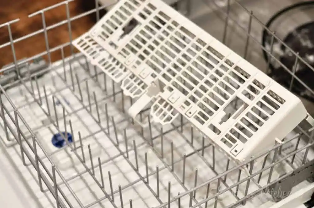 upside down utensil organizer in an empty dishwasher