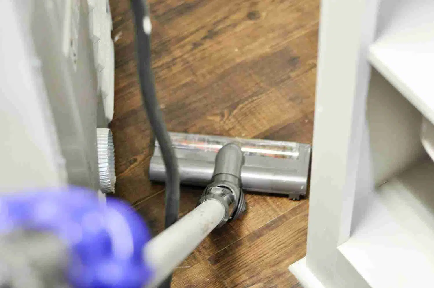 vacuuming behind a dryer