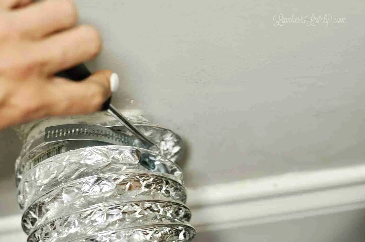 disconnecting a dryer vent hose from the wall