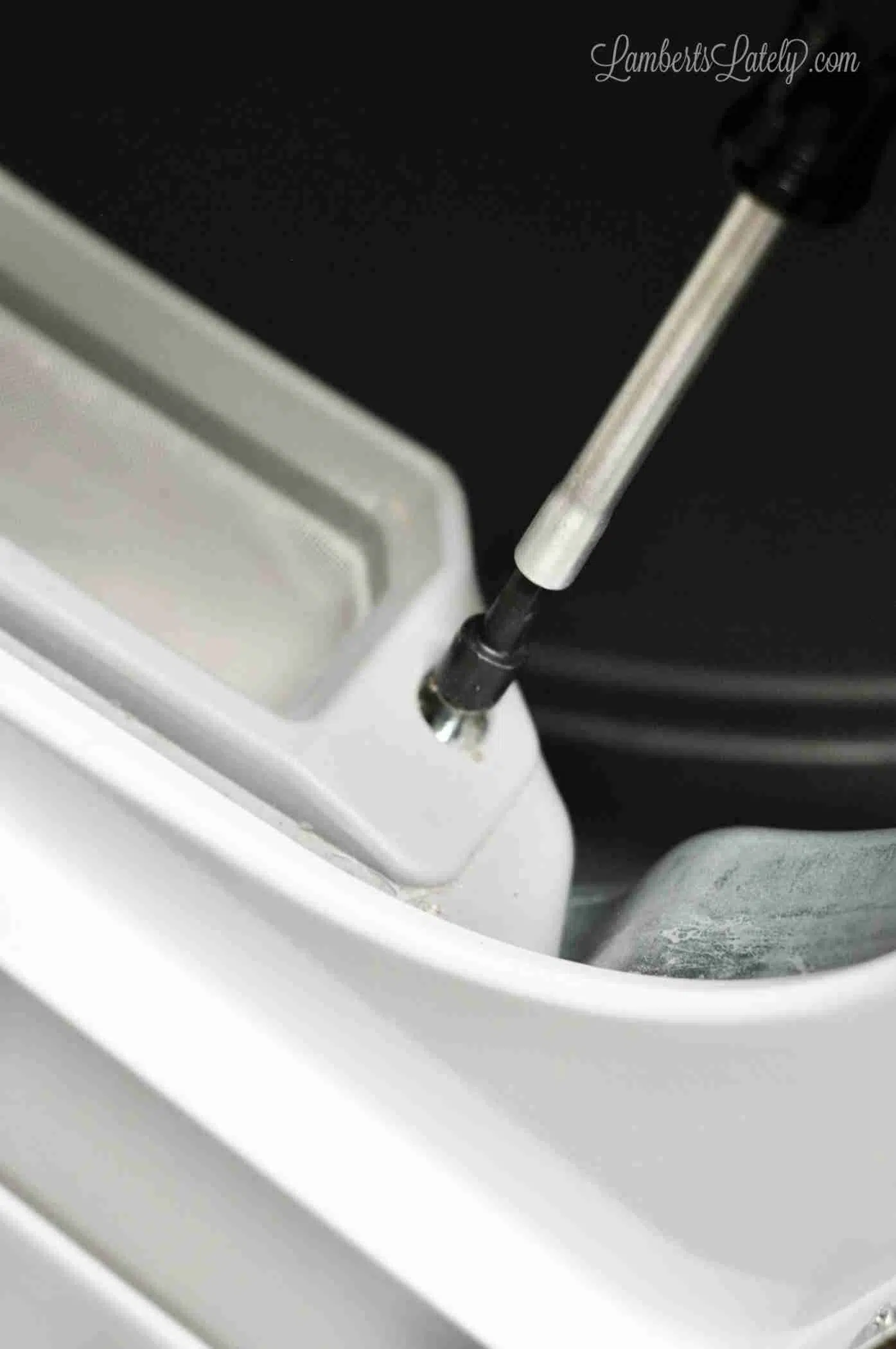 unscrewing lint filter on a speed queen dryer