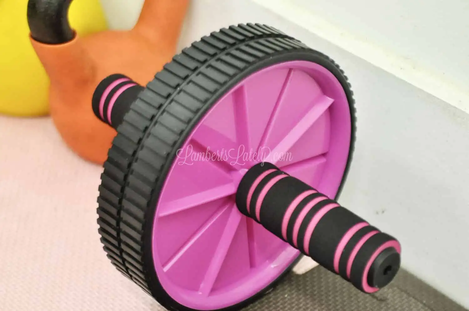 ab wheel lying on foam flooring.