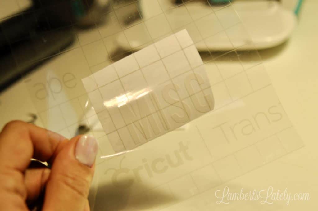 piece of transfer tape with vinyl and paper attached to back