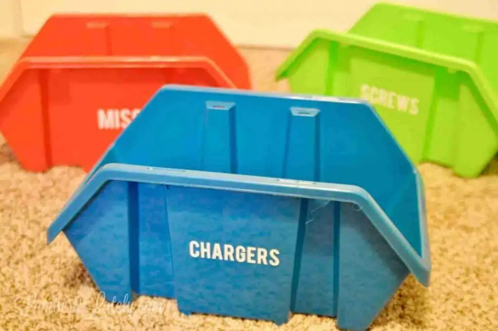 green, blue, and red storage bins labeled with a white vinyl word.
