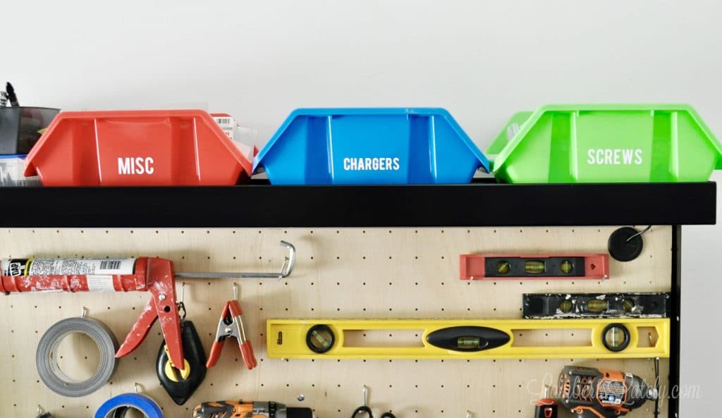 three plastic storage bins with labels