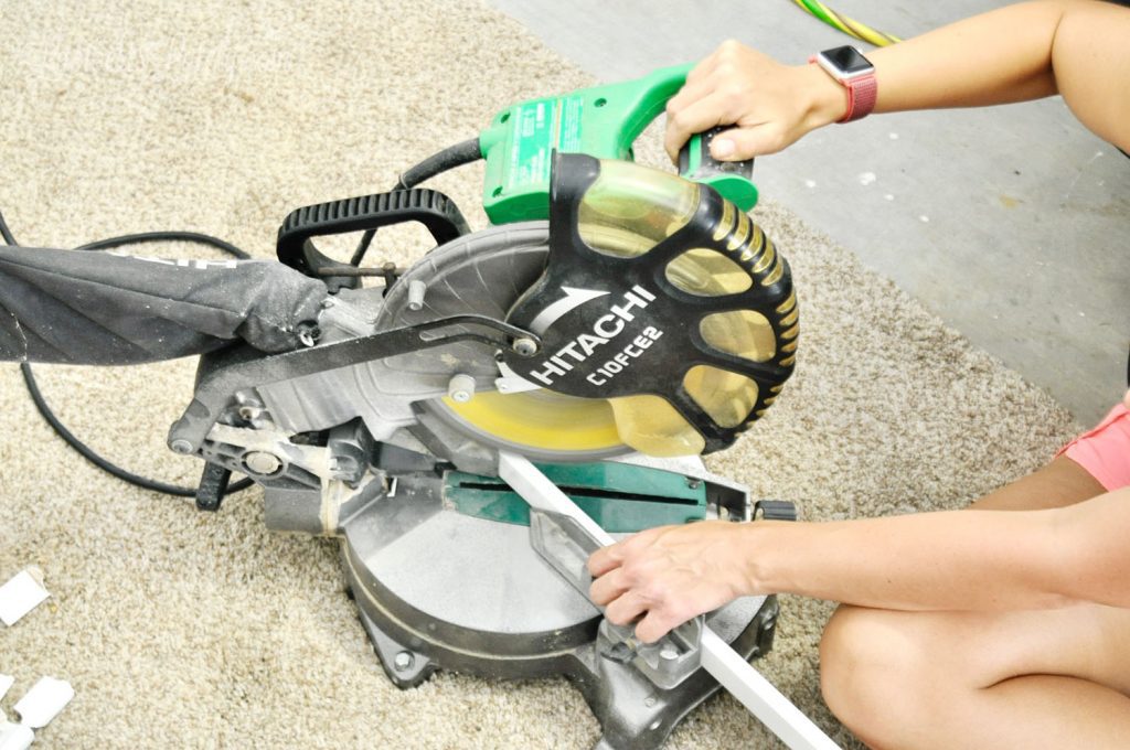 using a miter saw to cut molding.
