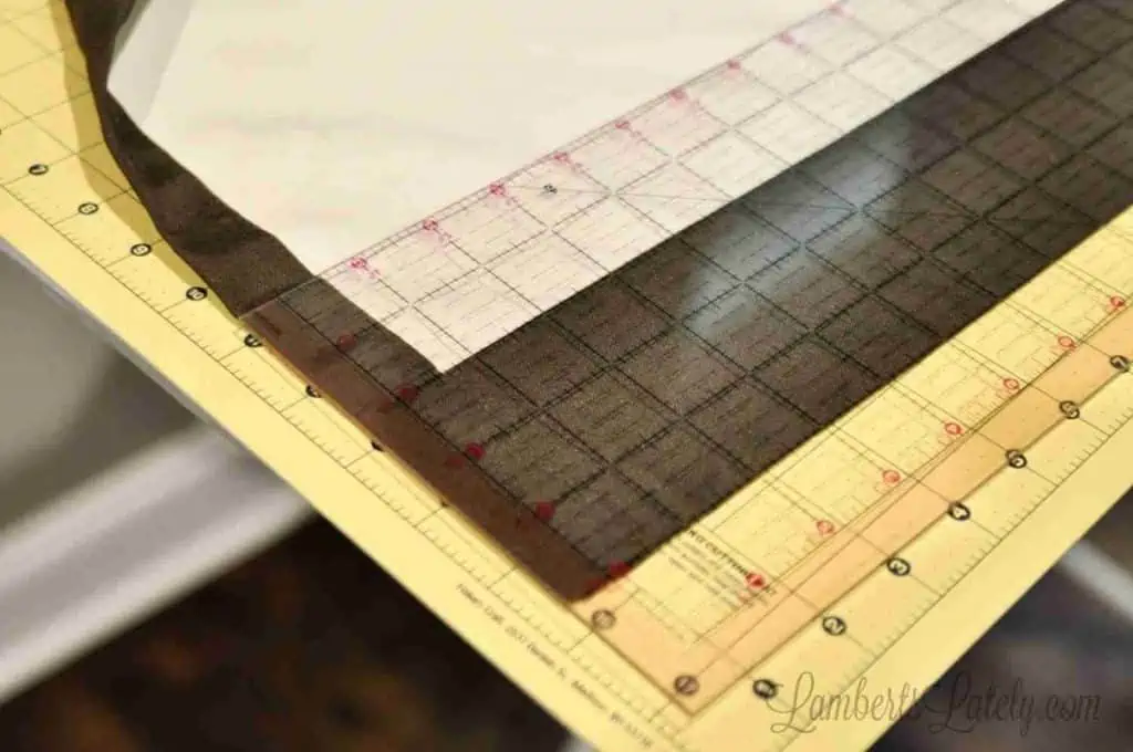 curtain fabric on a quilting mat with ruler.
