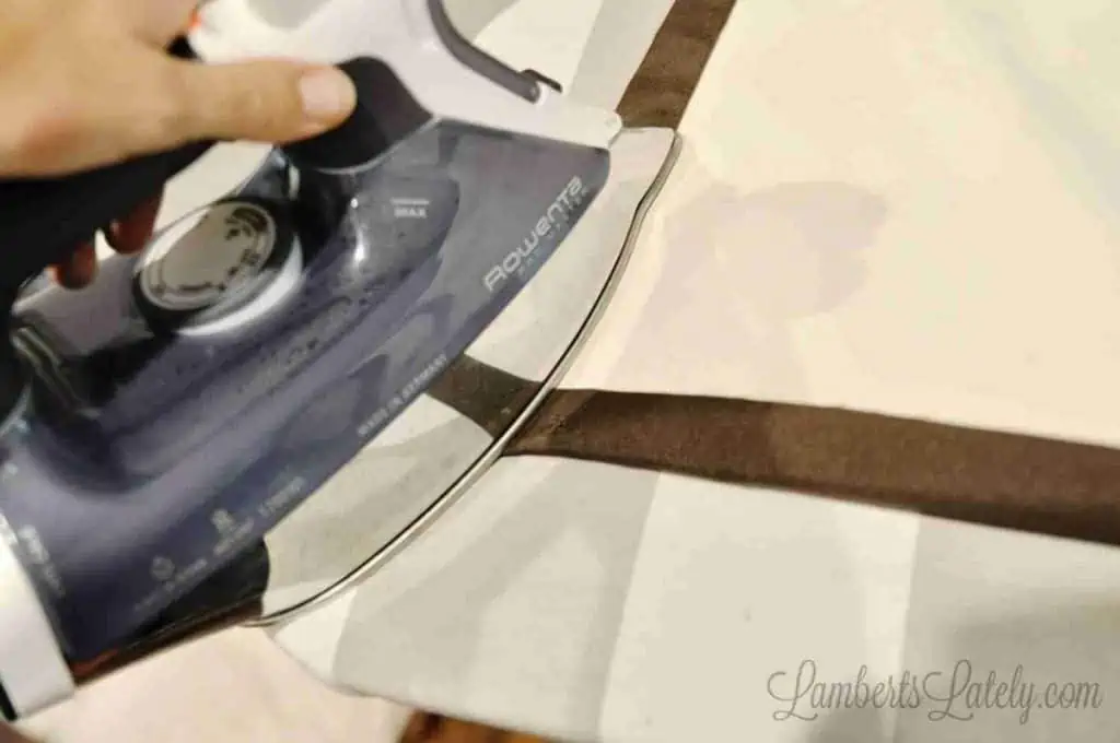 ironing hem of curtain.