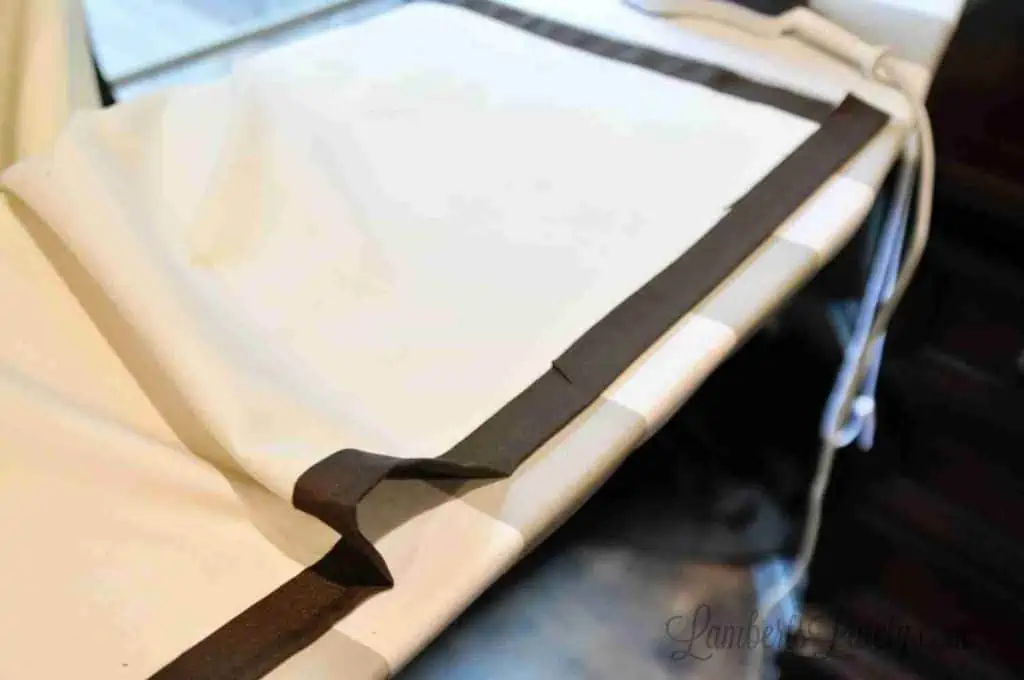 curtains, upside down, on an ironing board.