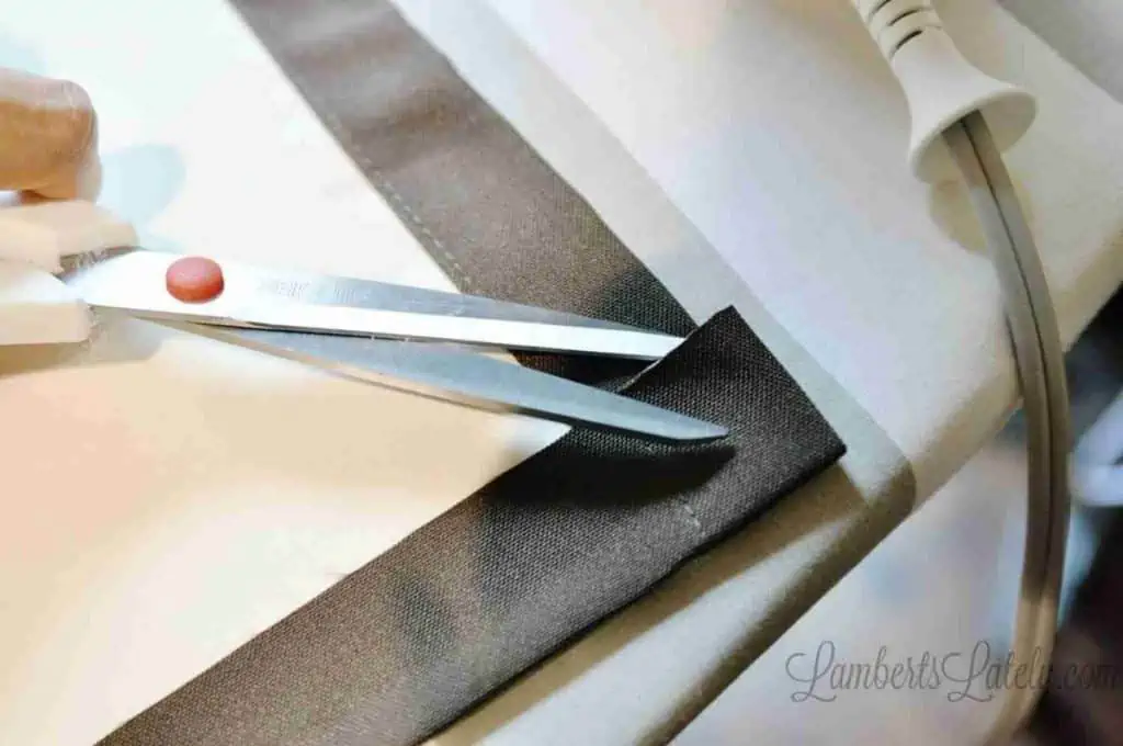 cutting back corner of curtain hem diagonally.