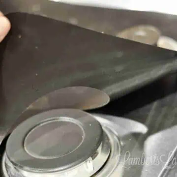 This post shows how to make a DIY Stove Splatter Guard - perfect for keeping kitchens/gas stovetops clean! This guard covers a gas stove to protect stainless steel from spills and stains.