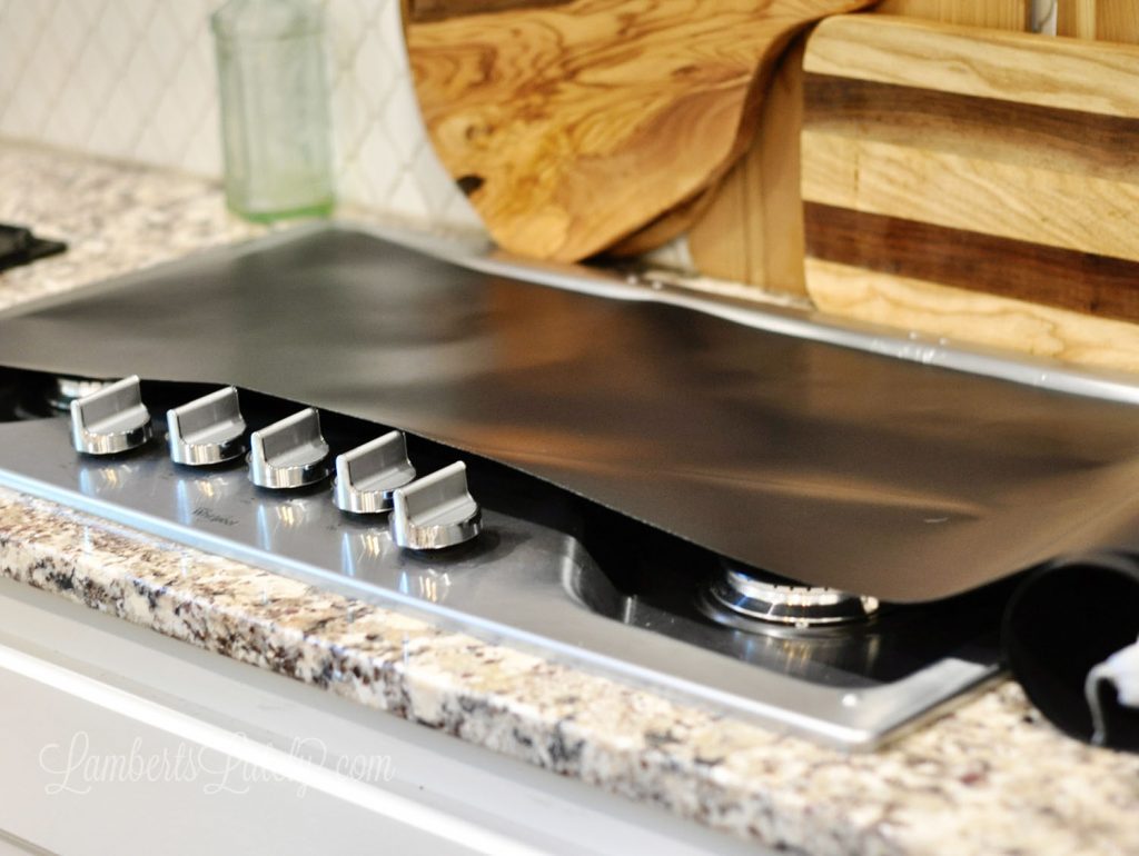 oven liner material on top of a gas stove