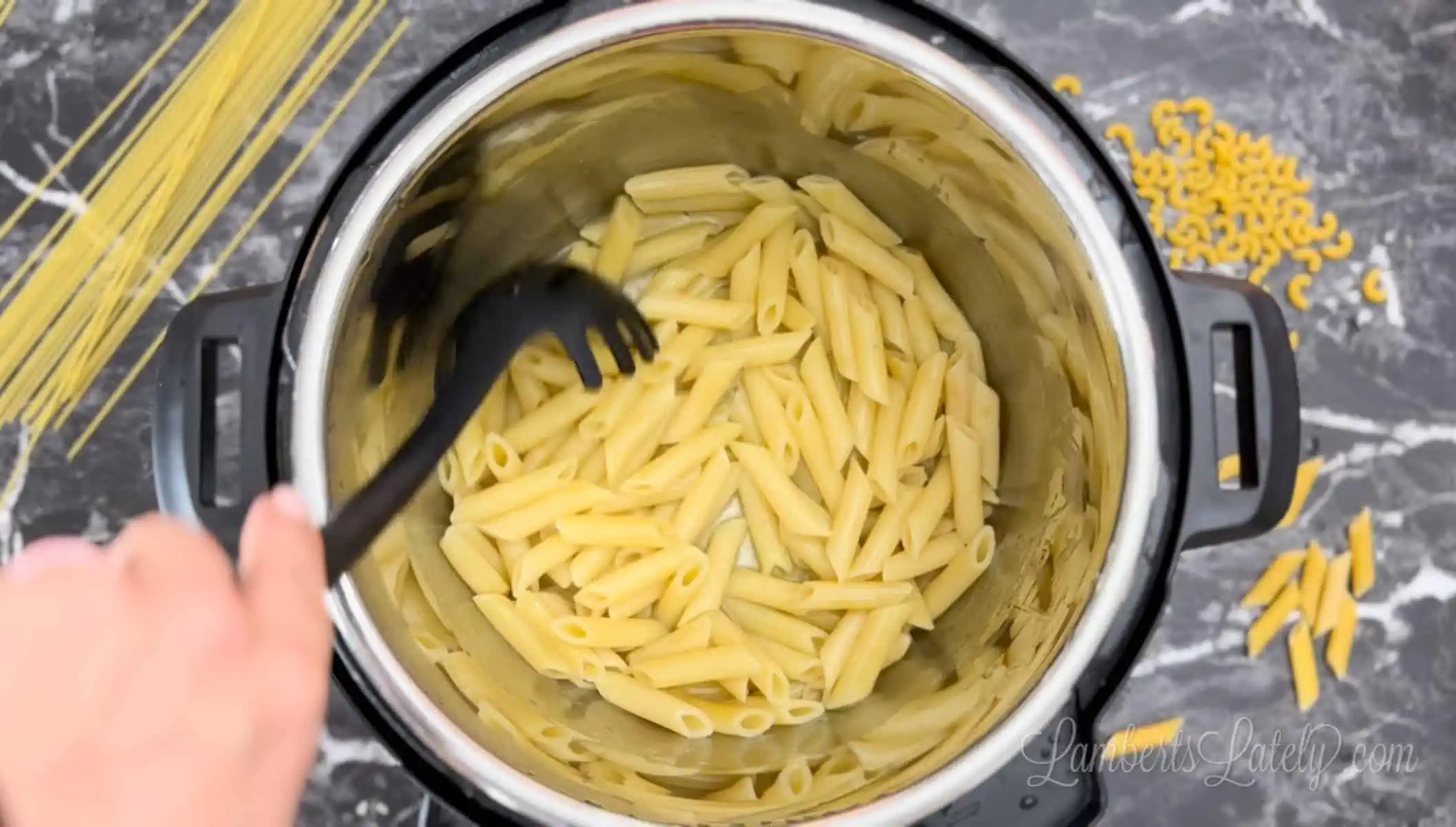stirring pasta in an instant pot.