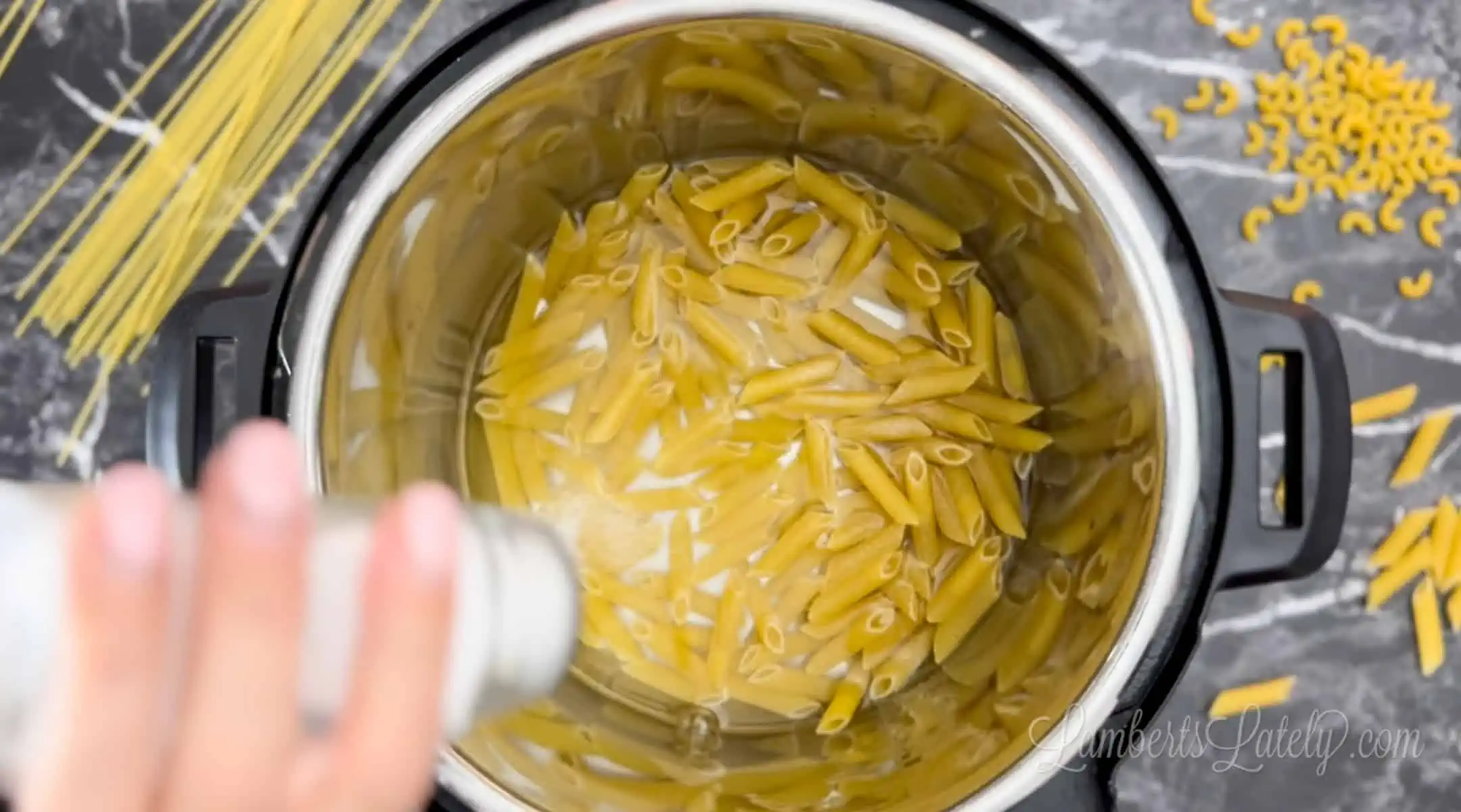 adding salt to pasta and water in an instant pot.