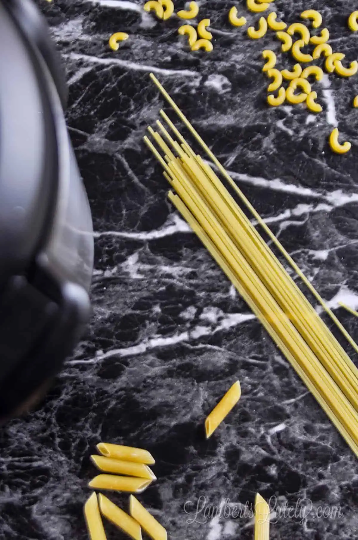 pasta on a dark counter, next to an instant pot.