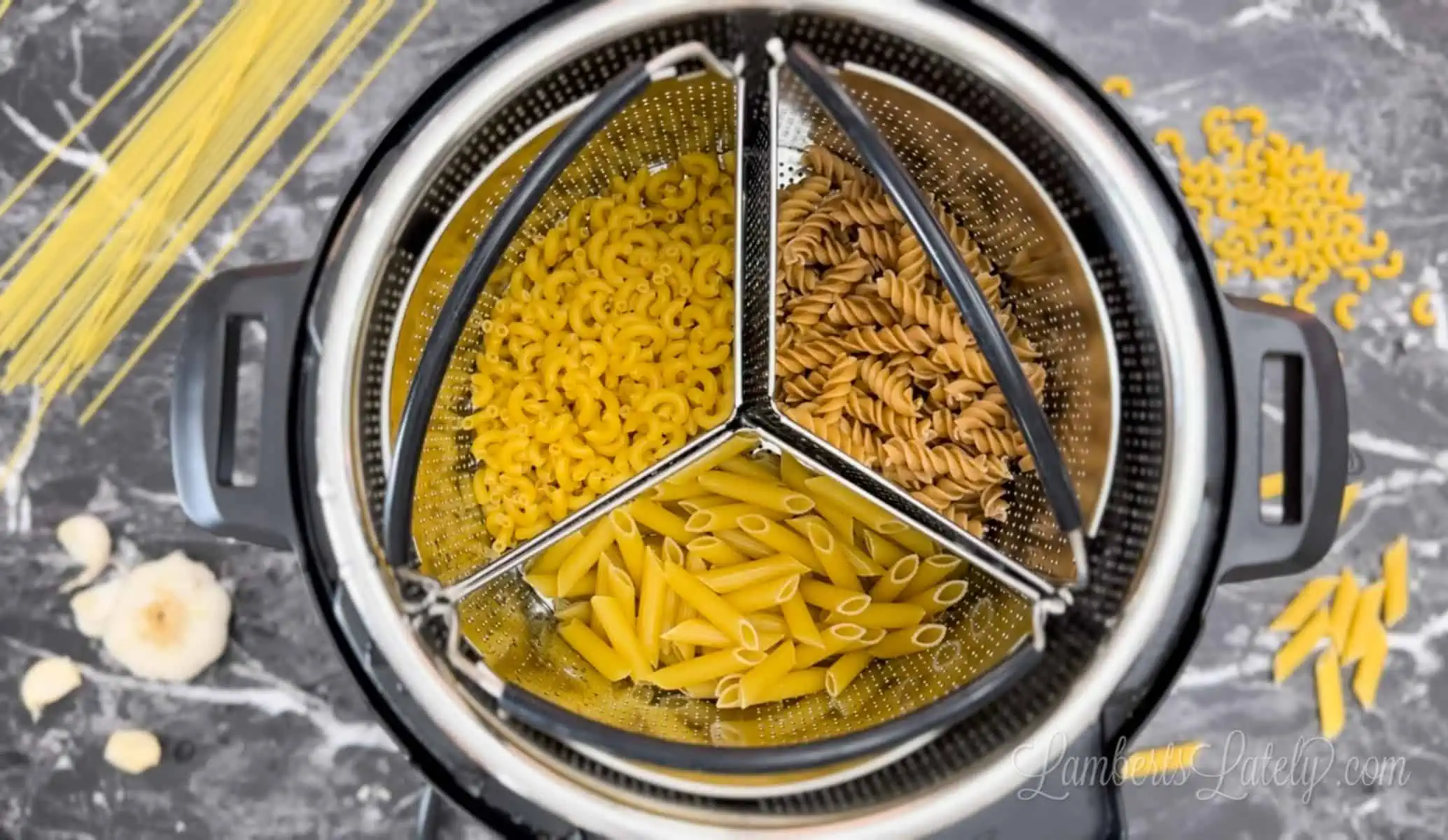 three types of pasta in steamer baskets in an instant pot.