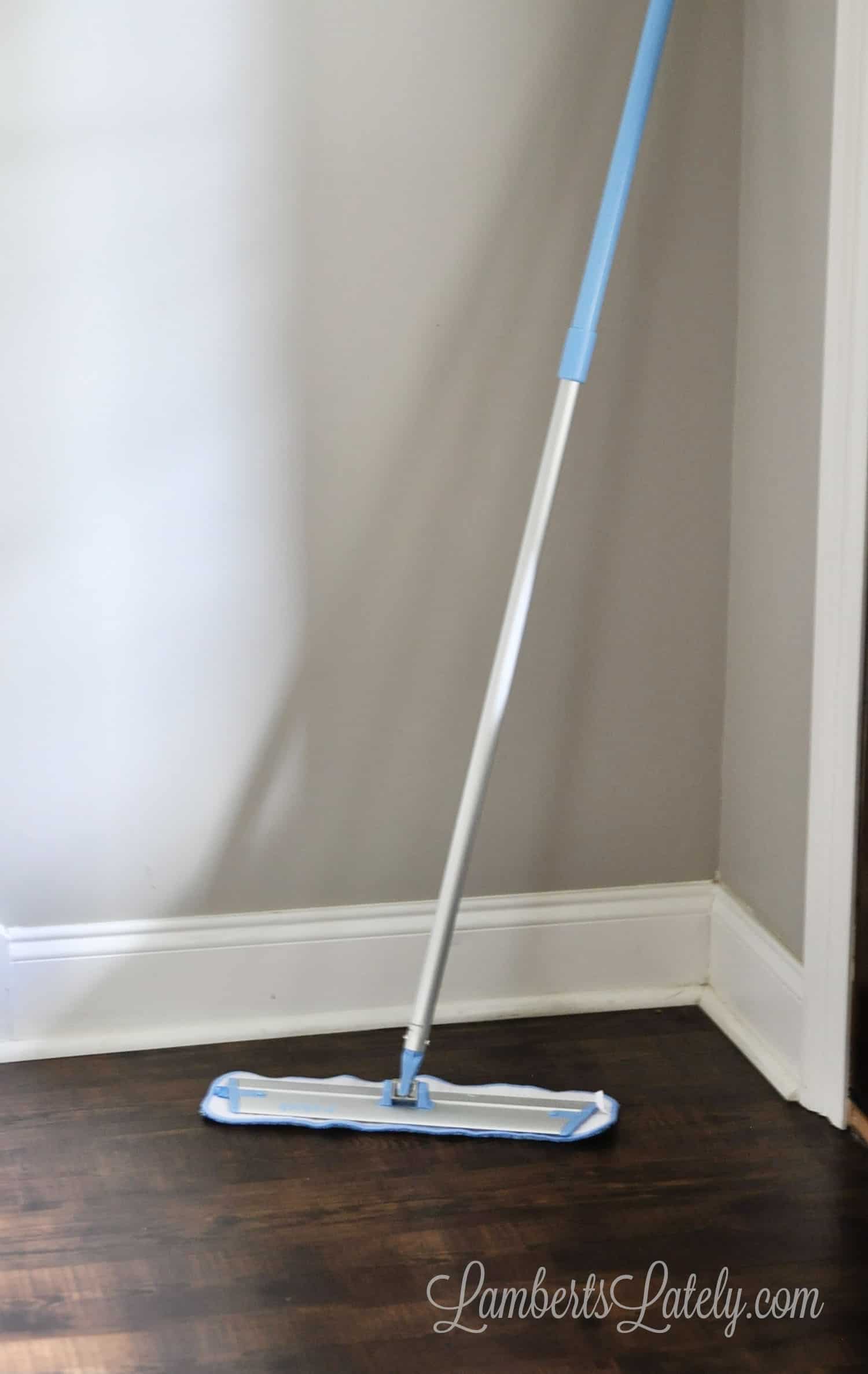 e cloth mop leaning against a wall.