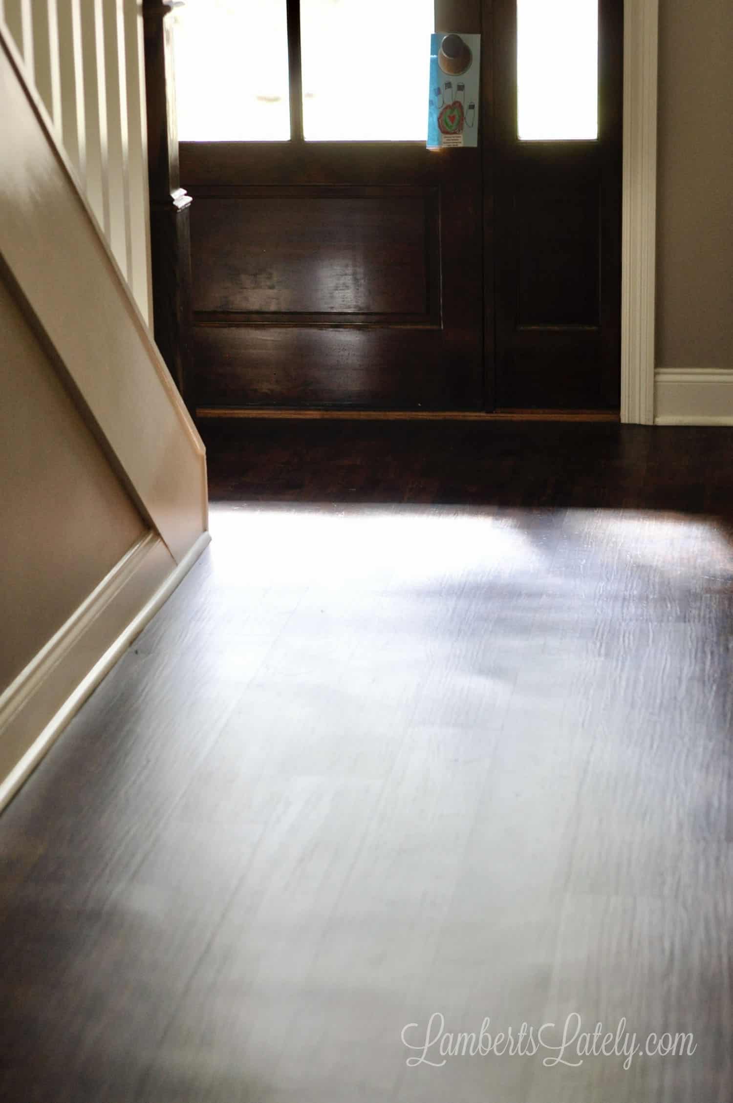 foyer of a home with dark vinyl plank flooring.
