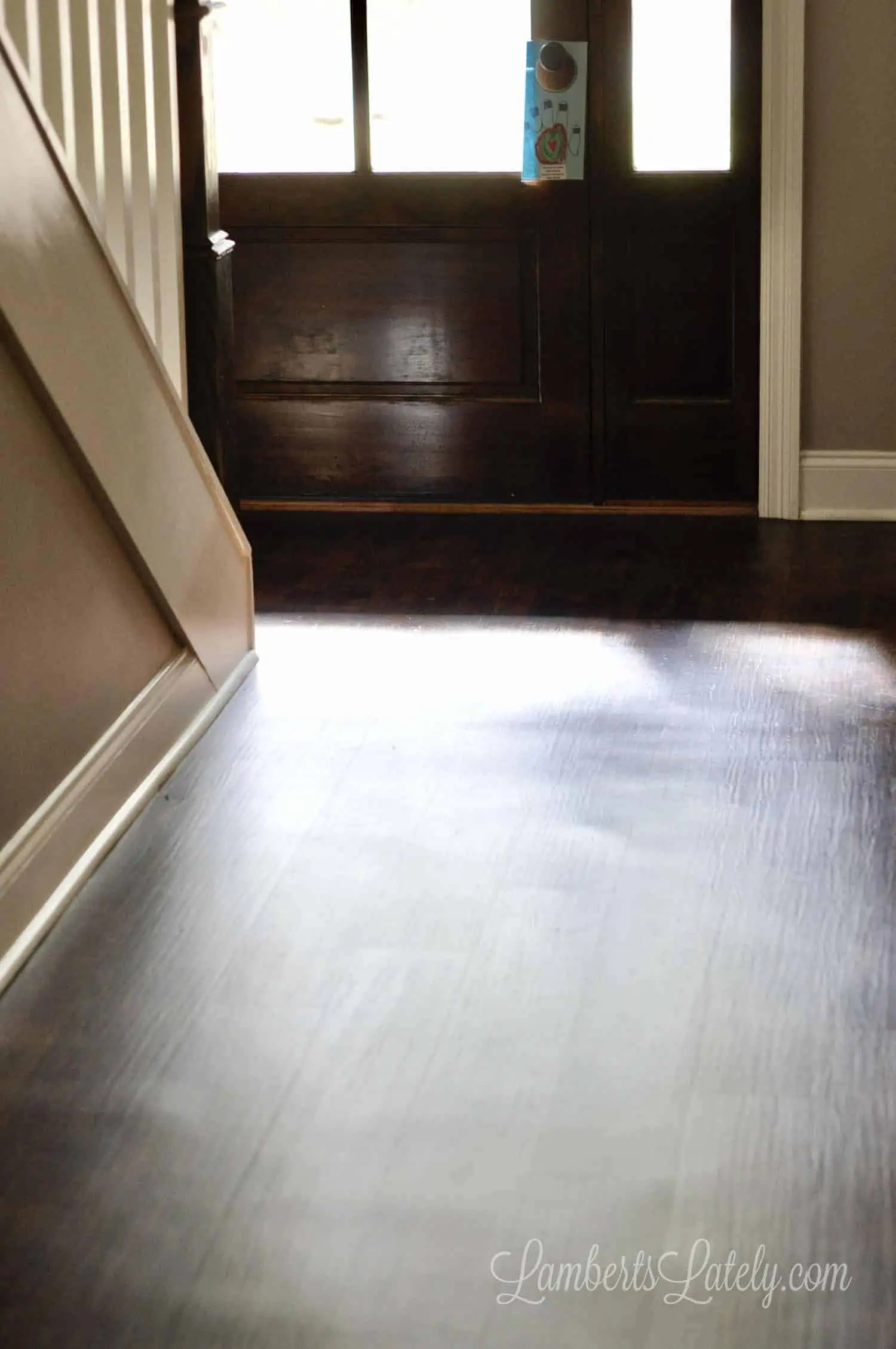 foyer of a home with dark vinyl plank flooring.