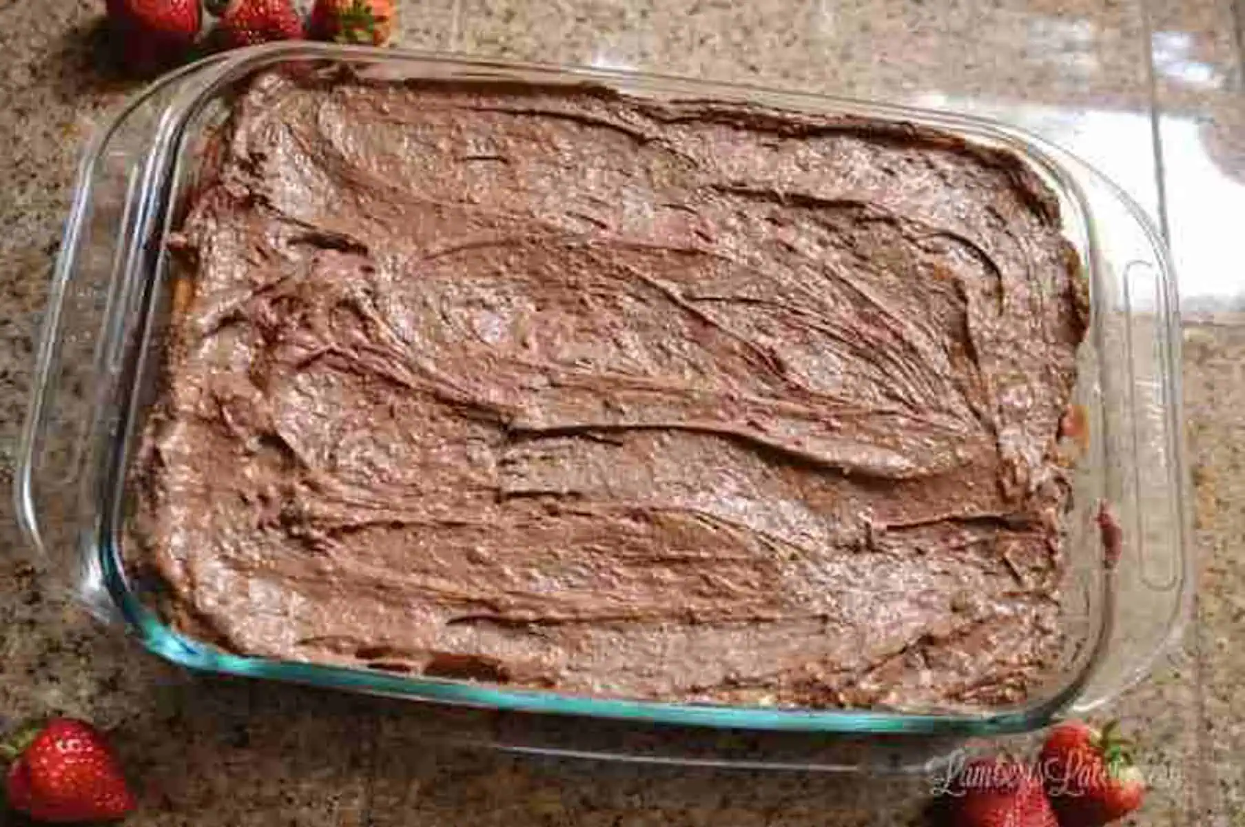 strawberry earthquake cake topped with chocolate frosting.