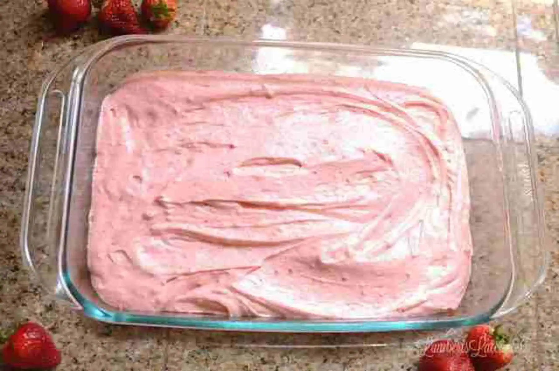 strawberry cake mix in a baking dish.