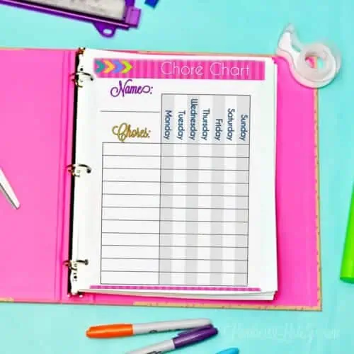 chore chart printable in a notebook on a desk.