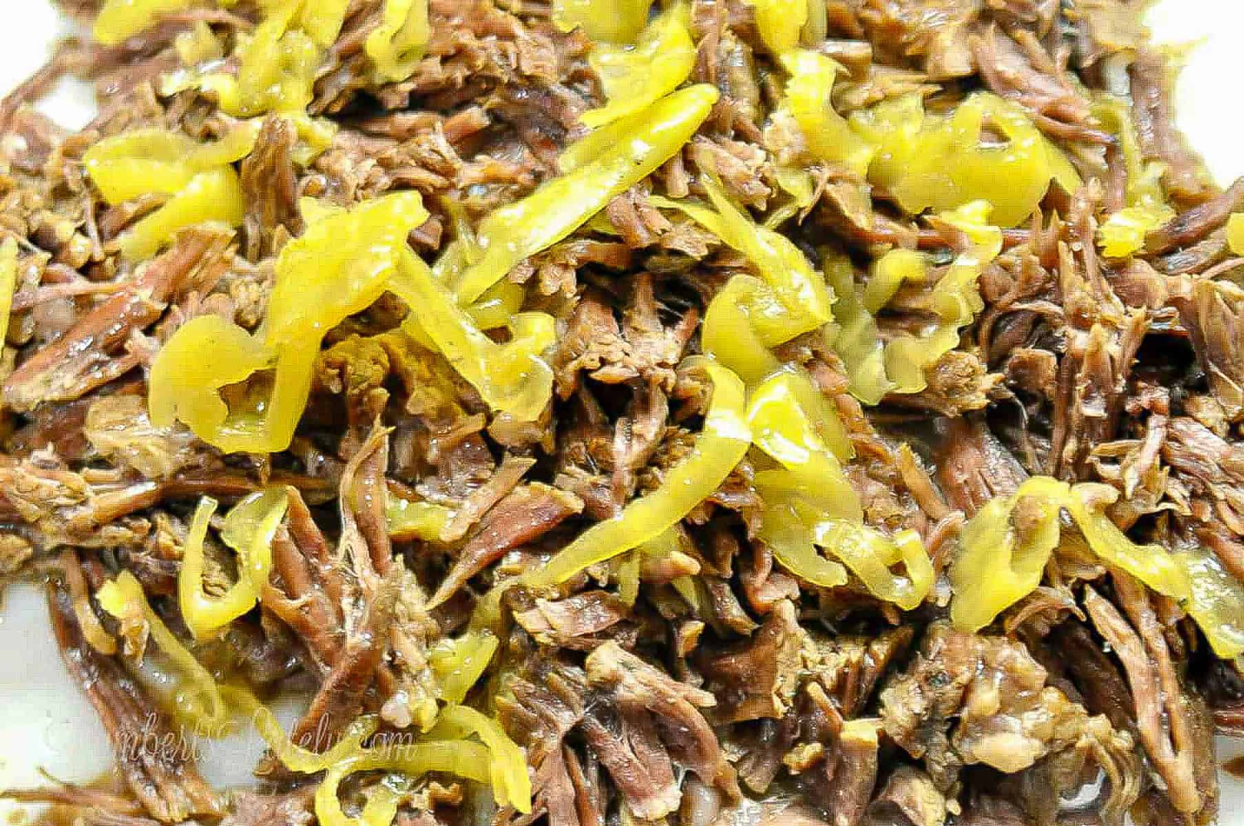 mississippi pot roast, shredded, covered in pepperoncini peppers.
