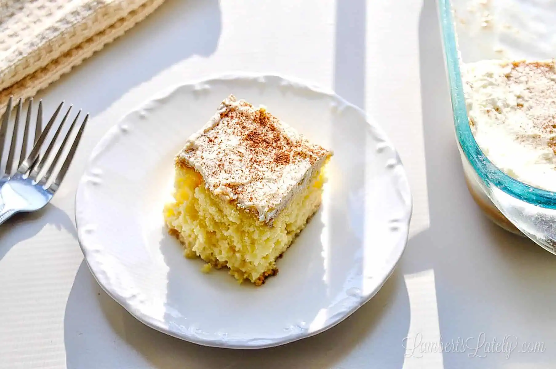 piece of tres leches cake on a plate.