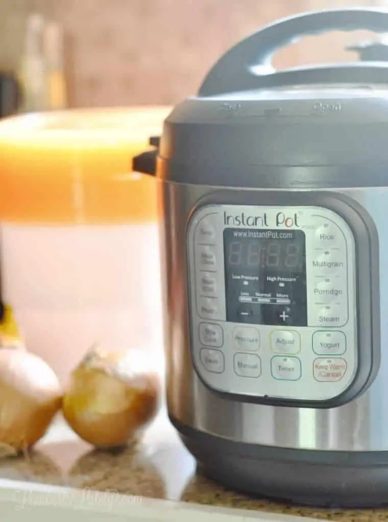 close up of instant pot with onions in the background
