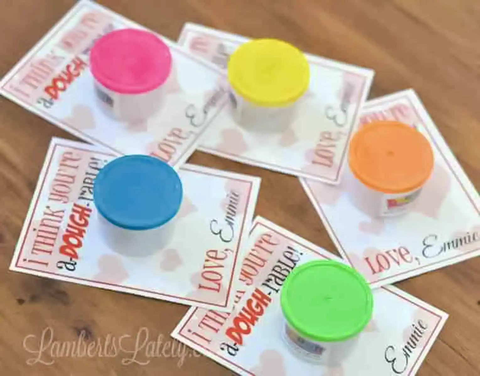 Free Printable Valentines for Play-Dough on a wood table.
