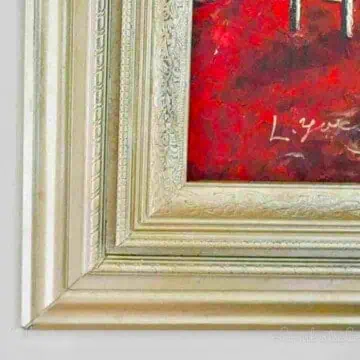 close up of the corner of a gold ornate picture frame.