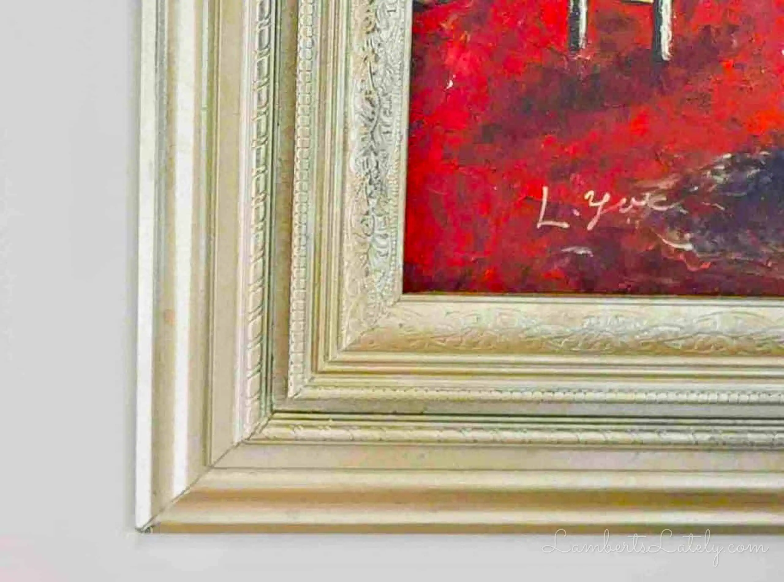 close up of the corner of a gold ornate picture frame.