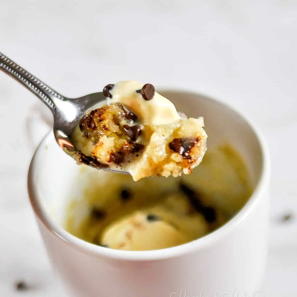 spoon of chocolate chip mug cake and ice cream.