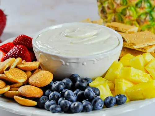 sweet cream cheese fruit dip with fruit and crackers.