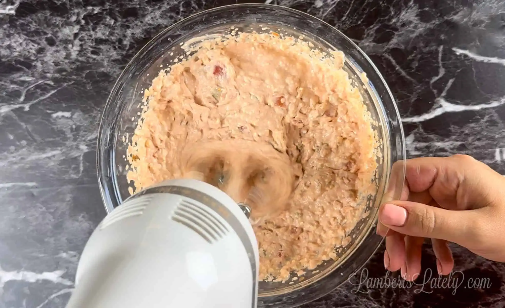 blending cream cheese and salsa in a bowl.