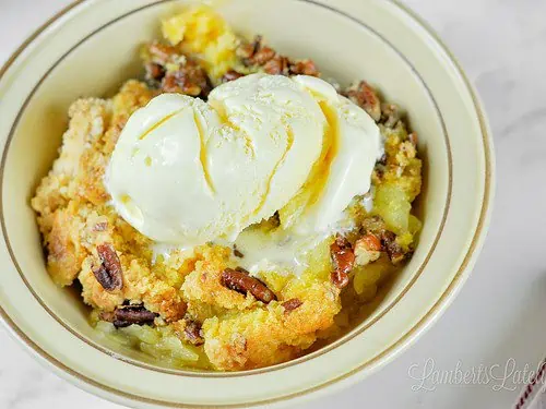 bowl of pineapple dump cake with ice cream.
