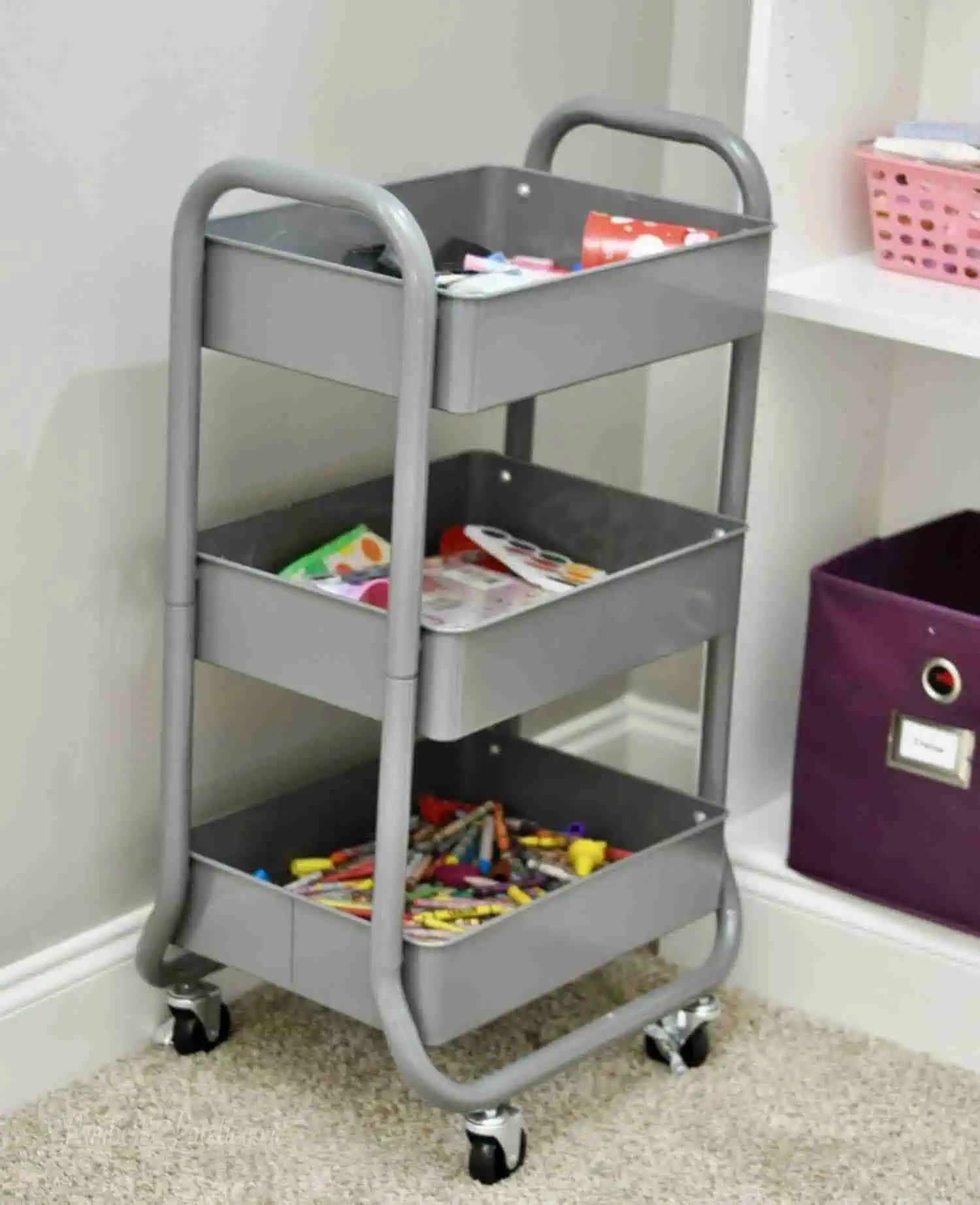 gray metal cart holding art supplies.