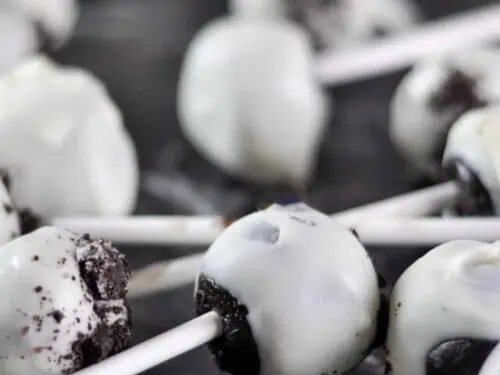 oreo cake pops laying on a counter.
