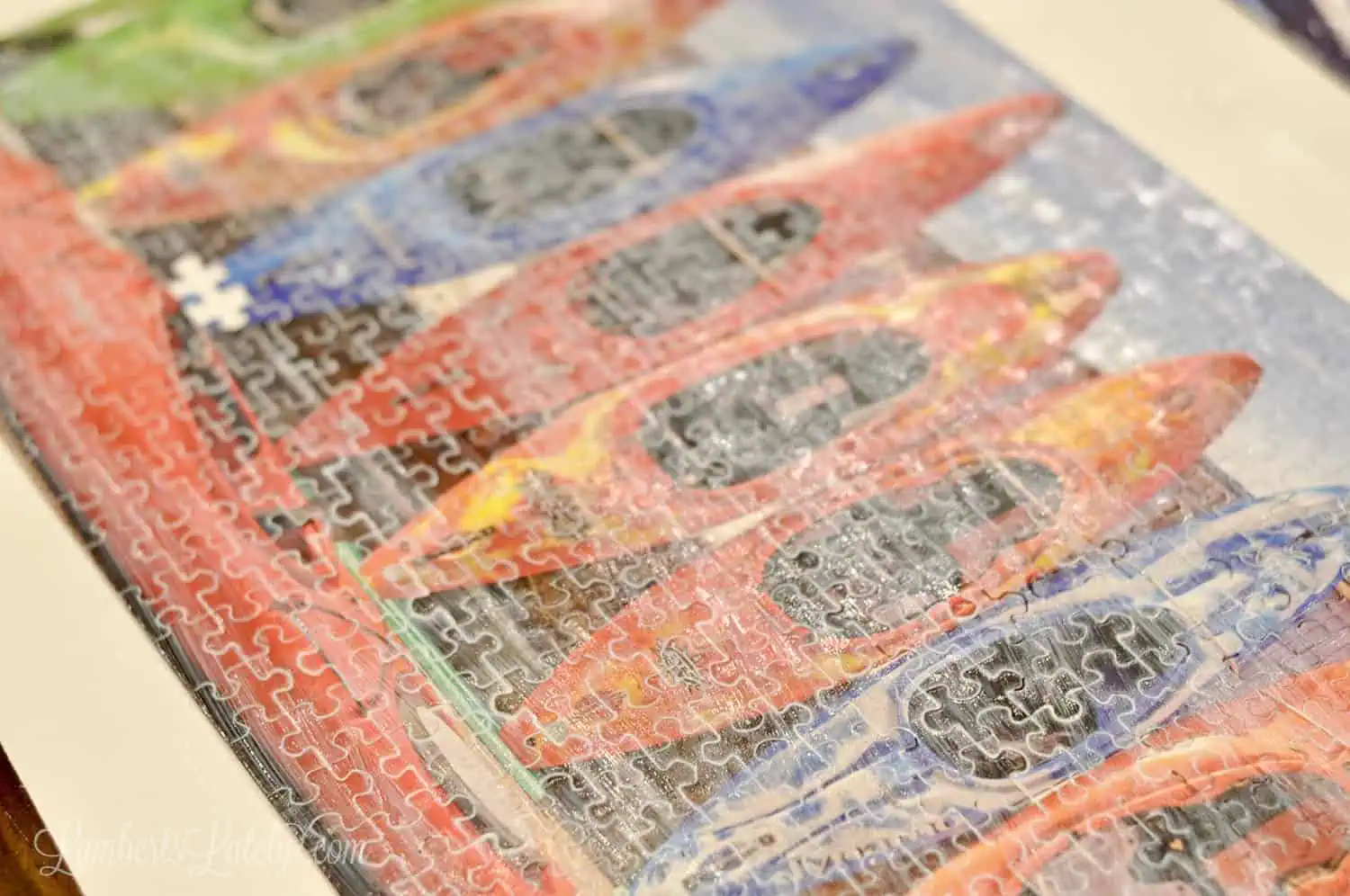 mod podge brushed onto the front of a puzzle.