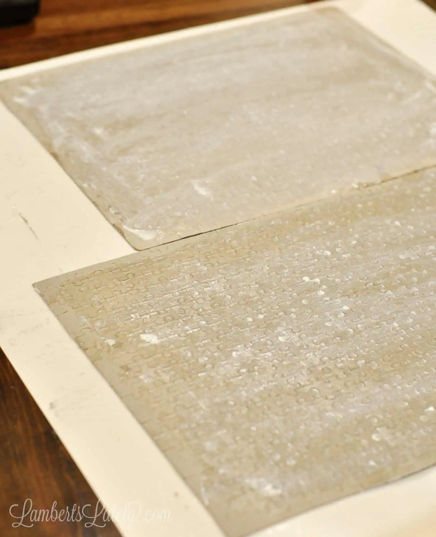 puzzles turned over on a piece of poster board, covered in glue.