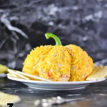 pumpkin cheese ball on a plate.