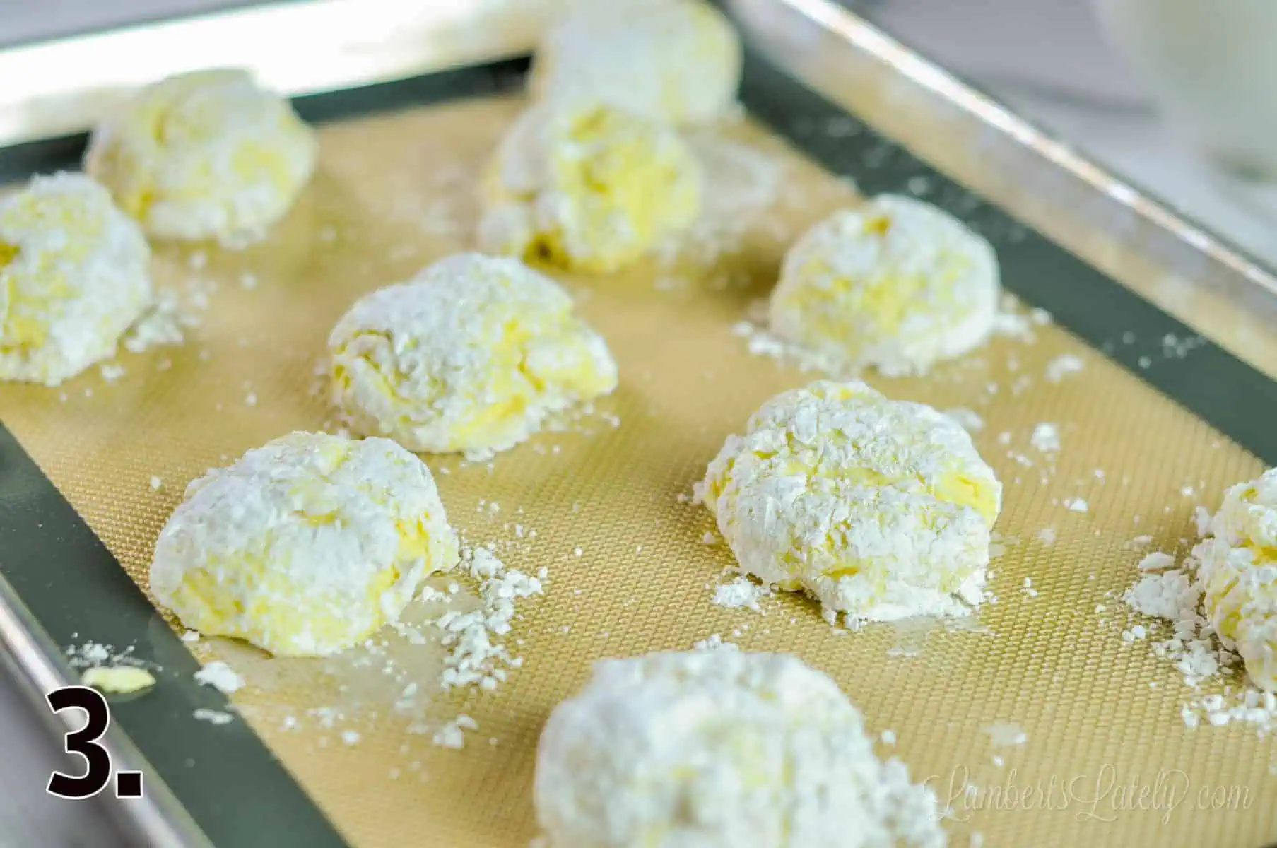 unbaked lemon cool whip cookies on a baking sheet.