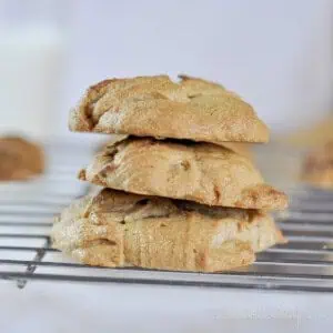 three peanut butter cookies stacked on a baking rack.