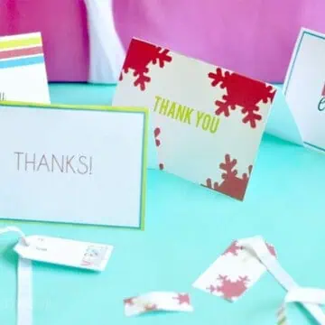 thank you notes spread out with gift tags and ribbon.
