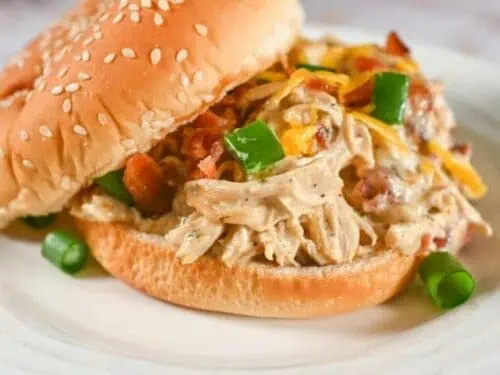 instant pot crack chicken on a sandwich bun, on a plate.