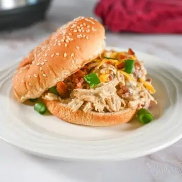 instant pot crack chicken on a sandwich bun, on a plate.