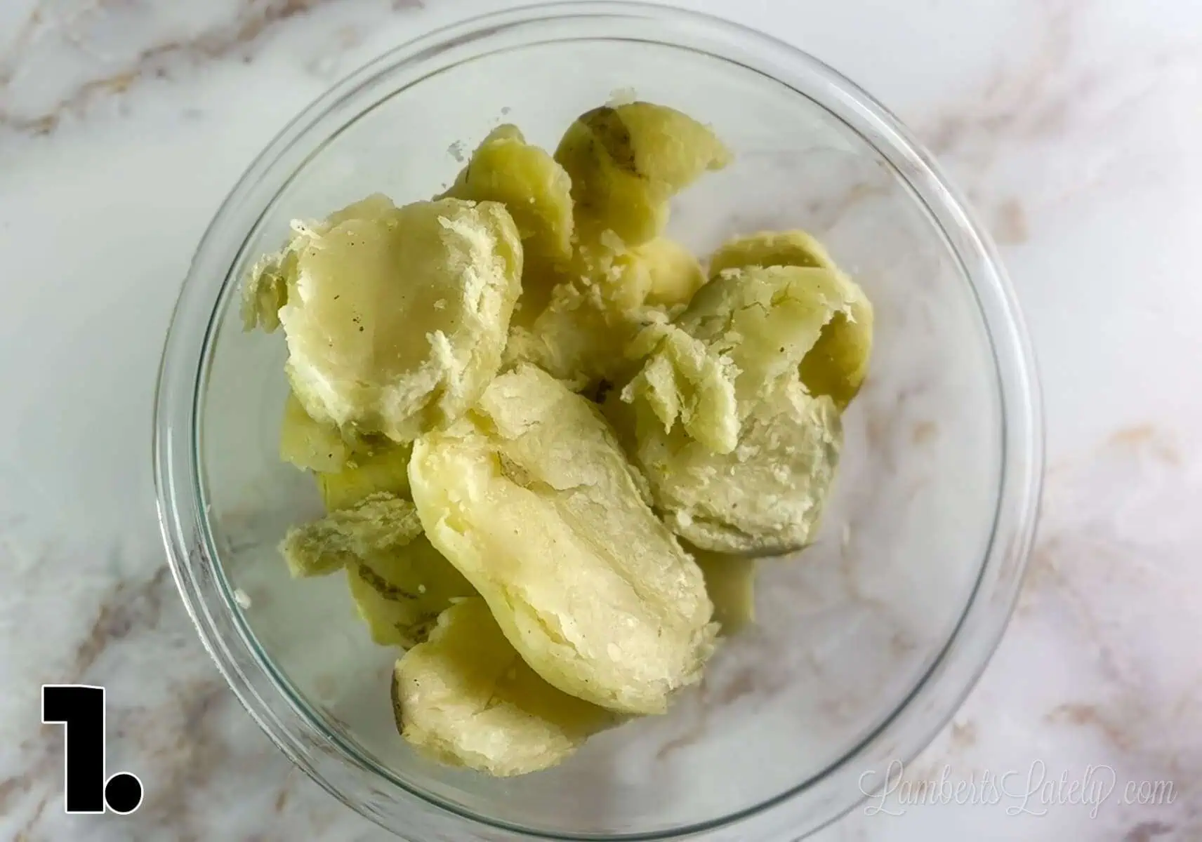 peeled potatoes in a glass bowl.